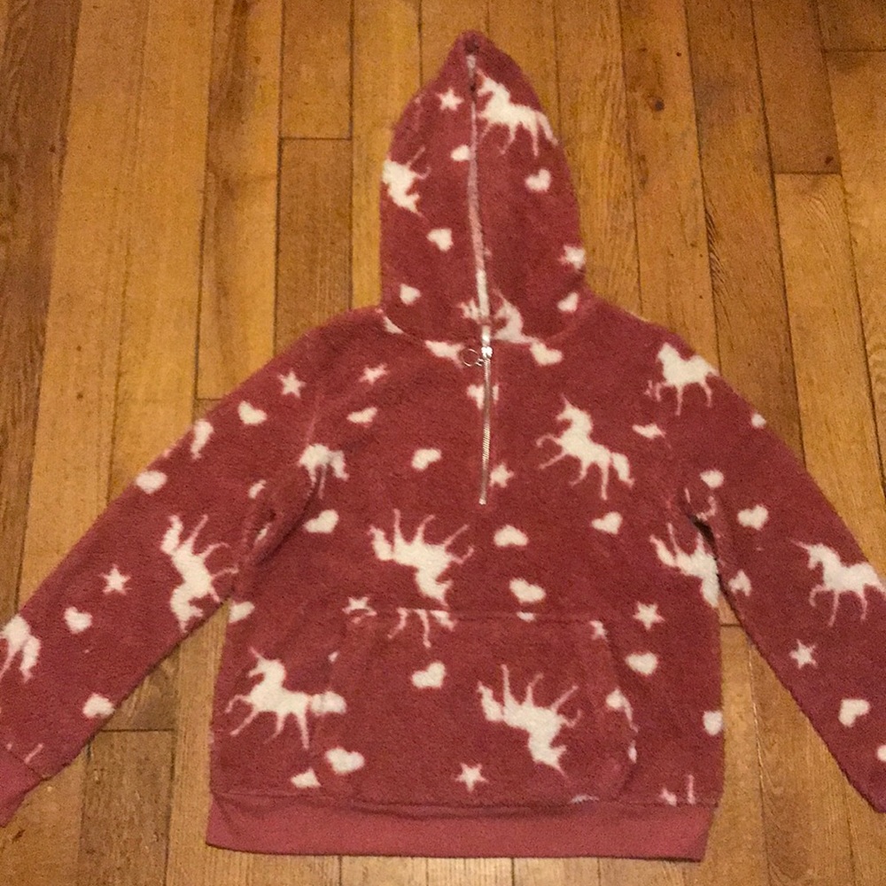 Sweater fuzzy and has unicorns on it.Plus shipping